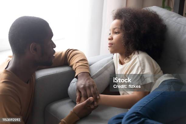 Father Hold Hand Little Daughter Lying On Sofa Feels Unwell Stock Photo - Download Image Now