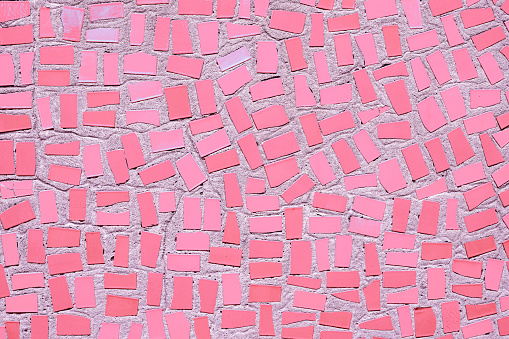 Closeup of pink coloured abstract mosaic ceramic tiles patterned background