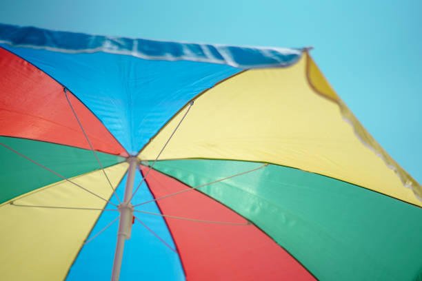 colorful beach umbrella against the sun light