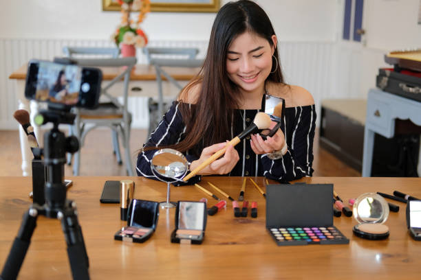 istock beauty blogger live broadcasting cosmetic makeup tutorial on social media. 1153593464