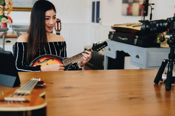istock blogger live broadcasting music instrument tutorial on social media. vlogger recording online vlog video. 1153593494