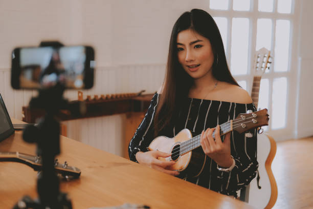 istock blogger live broadcasting music instrument tutorial on social media. vlogger recording online vlog video. 1153593495