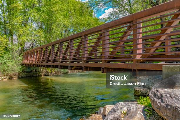 Bridge Over Glistening River With Rocks On The Bank At Ogden River Parkway Stock Photo - Download Image Now