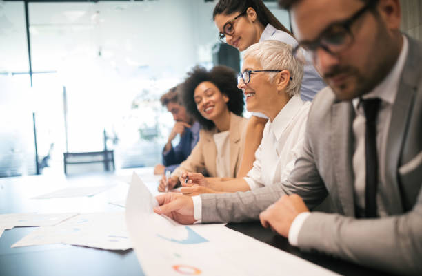 istock Group of successful business people at work in office 1153595147
