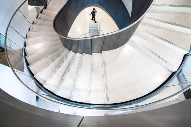 istock Abstract Spiral Staircase and Businessman 1153596614