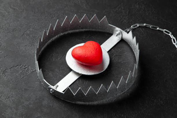 istock Trap with heart. Love is like bait. Black background. 1153598484