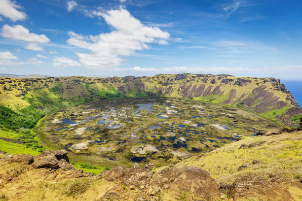 Rano Kau Volcano Crater Lake under blue summer sky. Rano Kau - Rano Kao - is a extinct volcano that forms the southwestern headland of Rapa Nui, Easter Island, Isla de Pascua, Polynesia, Chile.