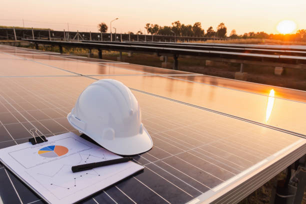 инженеры шляпу и график размещены на панели солнечных батарей, альтернативный источник электроэнергии, концепция устойчивых ресурсов - solar equipment audio стоковые фото и изображения