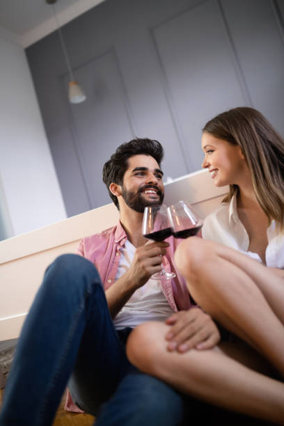 istock Beautiful couple is smiling and hugging while spending time together in bedroom 1153600112