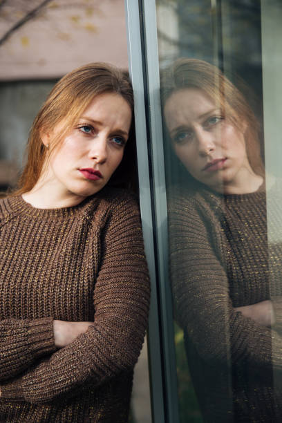 istock Attractive Depressed Woman Near the Window 1153600569