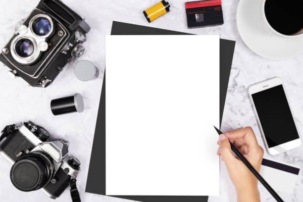 istock flat lay hand writing in a blank white page notebook decorated with vintage camera and photography tool on white marble background 1153600805