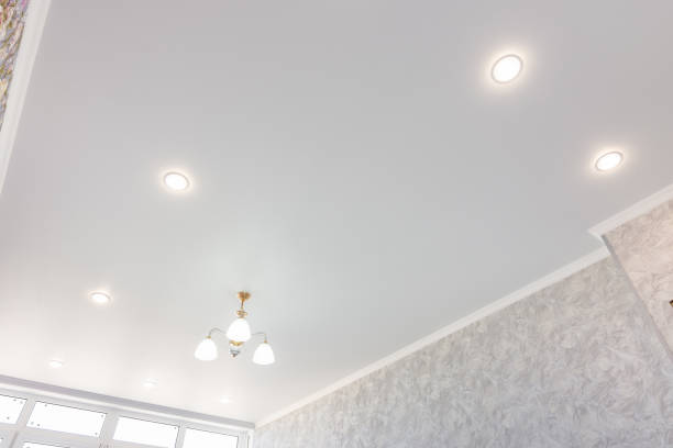 istock Stretch ceiling in the room with a chandelier and spotlights 1153606490