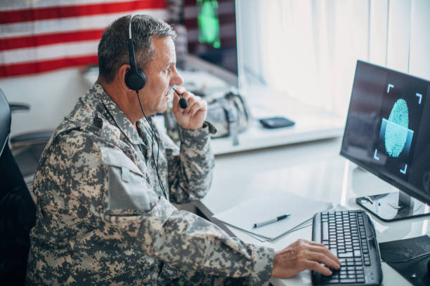 Top secret Army soldier using computer for identification blue digital fingerprint one mature man only audio stock pictures, royalty-free photos & images