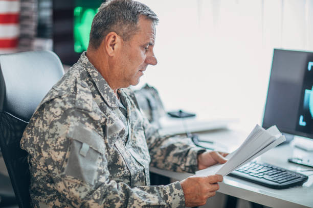 istock Army soldier working ona clasified document 1153609336
