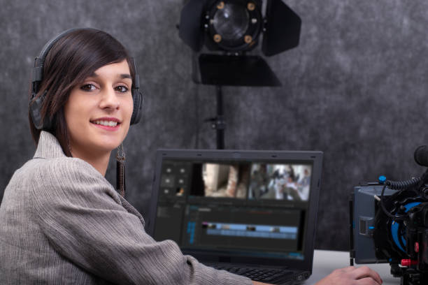 istock pretty young woman video editor working in studio 1153609959