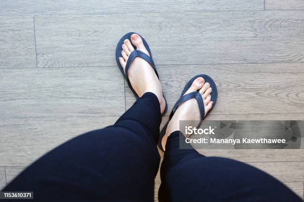 Black Flip Flops Isolated For Fashionable Close Up Of Legs Woman Top View Woman  Wear Black Footwear Sandals On Wooden Background Stock Photo - Download  Image Now - iStock