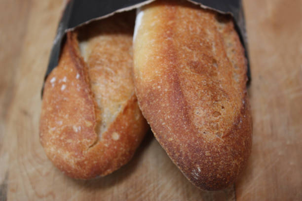 istock Bread sticks in a paper package   French cooking 1153615765