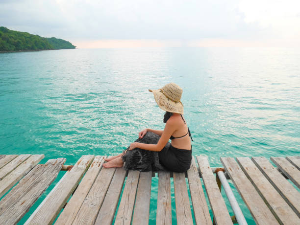 istock Woman in bikini with straw hat 1153616931