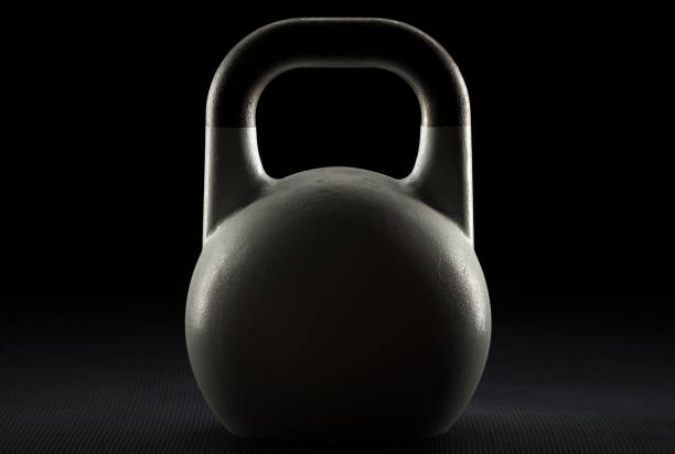 istock Rim lit white exercise kettlebell in a dark gym 1153617710