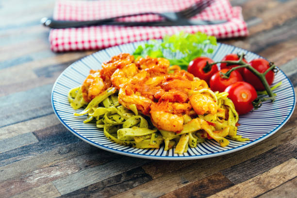 istock Small Gambas, stewed tomatoes, Tagliatelle with pesto 1153617752