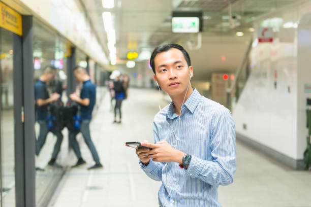 istock Typing a message while waiting for the metro in Taipei 1153618506