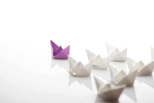istock Paper ships. Leadership concept using paper ship among white 1153620553