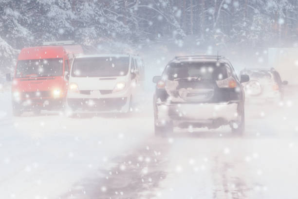 istock Driving in snow storm on bad winter Road 1153622095