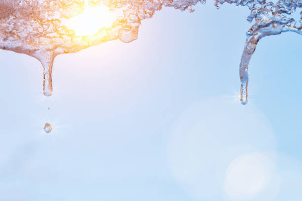 icicles sparkling white with water drops ice hanging down. Early spring icicles sparkling white with water drops ice hanging down icicles melting stock pictures, royalty-free photos & images