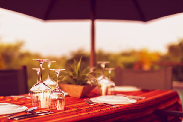 Africa, Holiday, Travel, Vacation - Wine Glasses and Crockery Set on a Dining Table Awaits its Guests at a Holiday Home in Africa