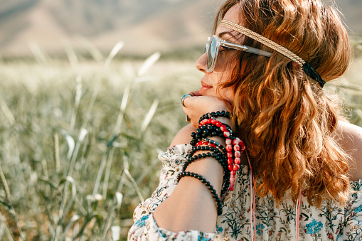 portrait of a young hippie girl on a wheat field