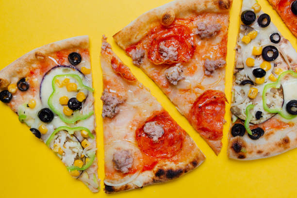 istock Pizza with pepperoni, tomato sauce and cheese,  different pizza,  sliced peppers, yellow background, Top view. Banner, close-up, copy-space 1153629018