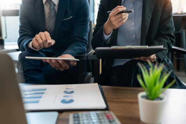 istock Midsection Of Business People Sitting At Office 1153629211