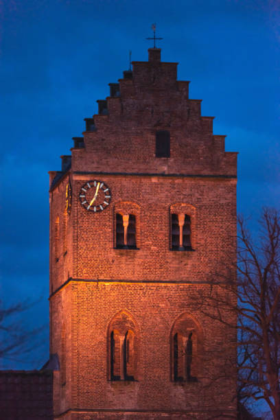 istock Lit ancient church tower at dusk. 1153632226