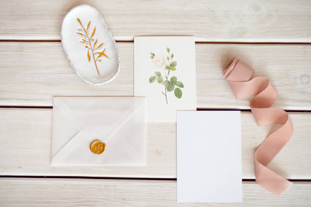 Feminine wedding desktop mock-up with blank paper card and Eucalyptus populus branch on white shabby table background. Empty space. Styled stock photo, web banner. Flat lay, top view.
