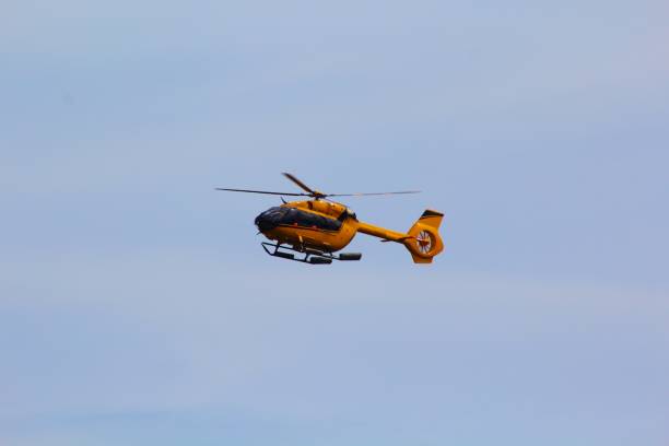 istock Yellow helicopter coming into land 1153632698