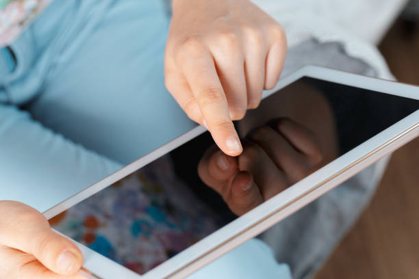 istock woman holding digital tablet, closeup 1153633743