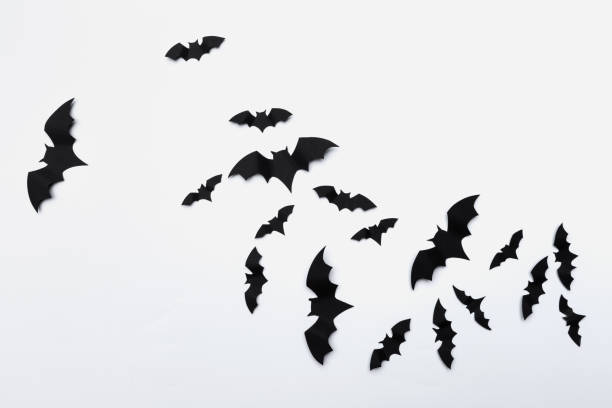 halloween and decoration concept - paper bats flying