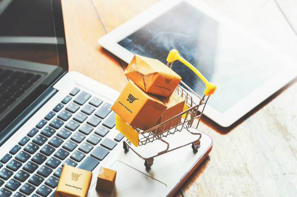 istock Boxes in a trolley on a laptop keyboard. Ideas about online shopping. 1153636940