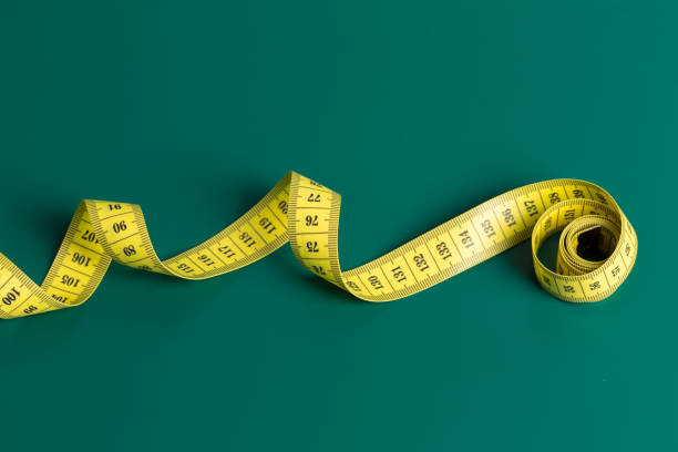 istock measure tape on a green background 1153638763