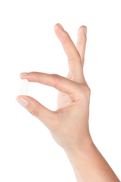 istock pills in woman hand 1153641048