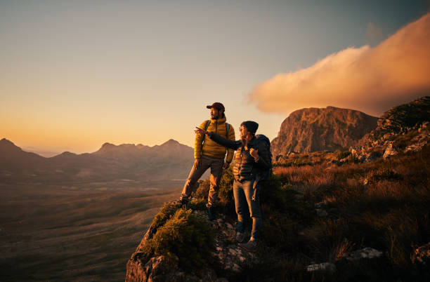 the achieved their set goal of reaching the peak - mountain peak mountain climbing men imagens e fotografias de stock