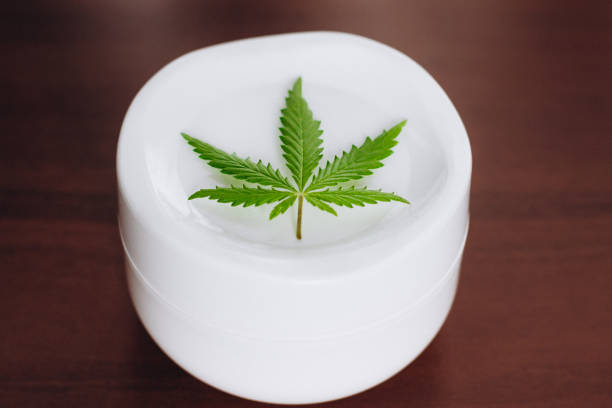 istock Moisturizing hemp hand cream in dose with green cannabis leaf. Cannabis cosmetics. Cream from biological and ecological plants of hemp vegetable pharmaceutical oil CBD 1153641296