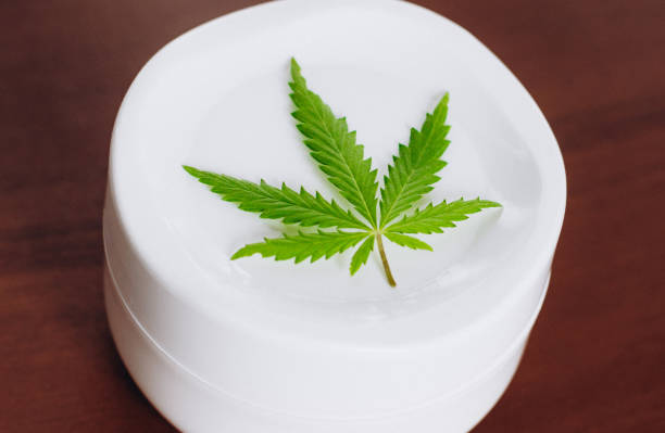 istock Moisturizing hemp hand cream in dose with green cannabis leaf. Cannabis cosmetics. Cream from biological and ecological plants of hemp vegetable pharmaceutical oil CBD 1153641347