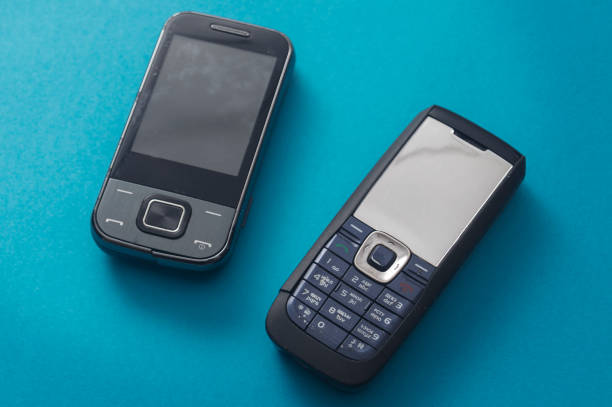 istock Old retro mobile phone on blue background, 1153643138