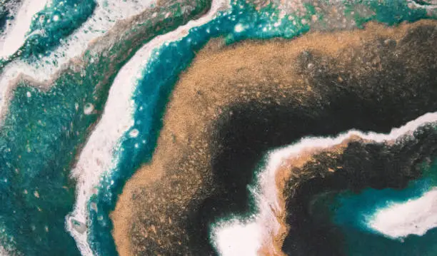 Photo of Abstract agate background, turquoise & gold seashore fluid