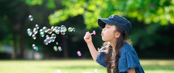Girl playing with soap bubbles