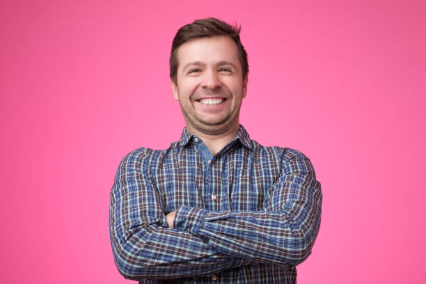 istock young man in shirt standing with arms crossed 1153646513