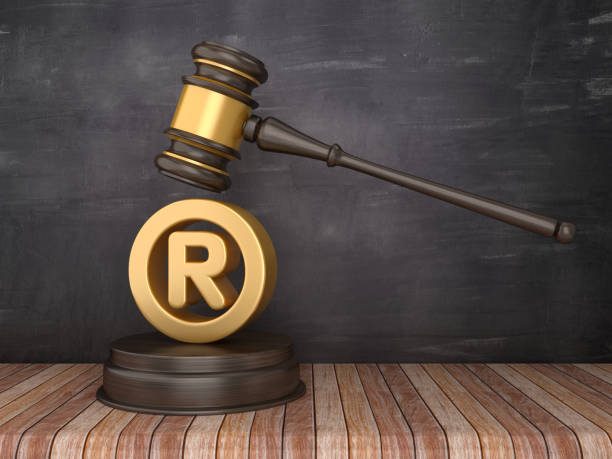 istock Gavel with Registered Trademark Symbol on Chalkboard Background - 3D Rendering 1153646953