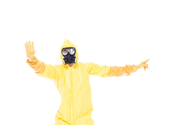 istock Man in protective clothing holding hands out in a stop gesture 1153646992