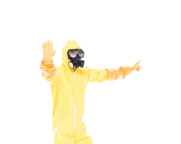 istock Man in protective clothing holding hands out in a stop gesture 1153647003
